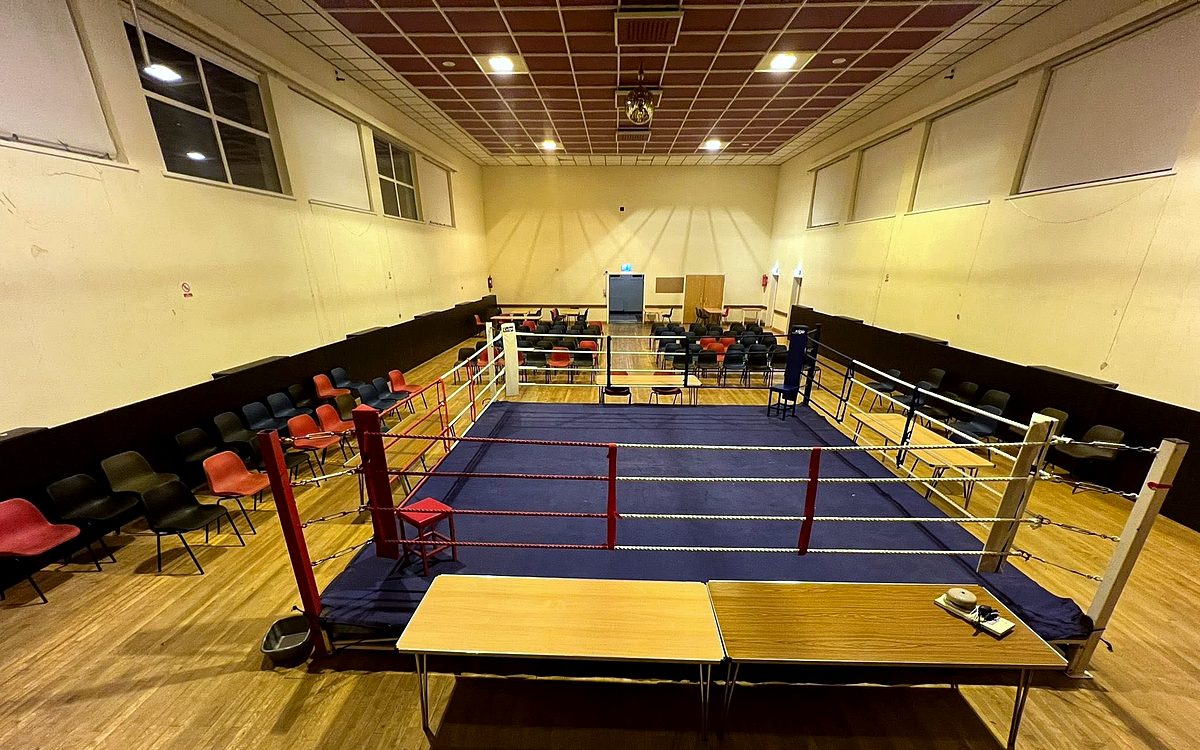 The main hall set up for a boxing event, with the ring in the centre and seating around it