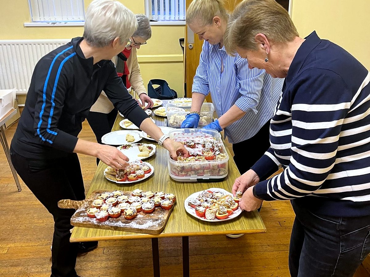 Volunteers plating up traybakes and refreshments in the Marian Hall